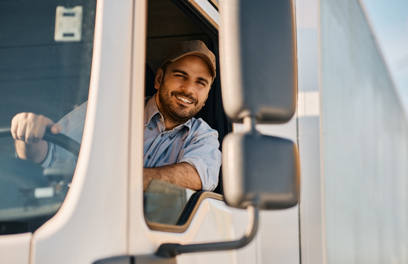 Trucker smiling from the window of a truck