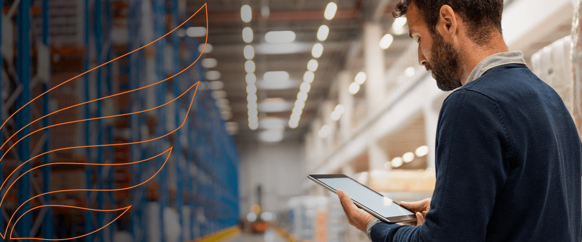 Man checking warehouse inventory on a tablet