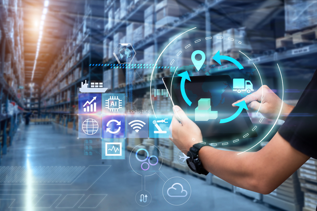 A person uses a tablet in a warehouse, surrounded by digital graphics representing logistics, data, and technology concepts. The scene captures the essence of creating RFPs with precision and understanding transportation rates within a comprehensive guide to streamline operations.