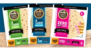 Three packages of La Tortilla Factory carb-cutting tortillas in flour, whole wheat, and zero net carb varieties on a sandy surface with a blue background.